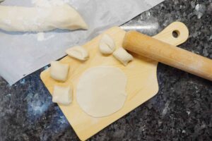 chinese dumpling recipe - 7. Use rolling pin to roll the small dough into flat circular dumpling skin
