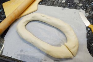 chinese dumpling recipe - 6. Make the dough into a donut-shape then into a circular shape. Cut it at one point to form a long dough