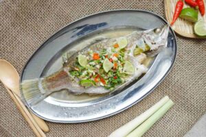 Thai-style steam fish recipe - the fish is served on the table.