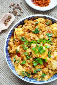 Chinese Si Chuan Ma Po Tofu with spring onion sprinkle on top, Si Chuan pepper and spicy powder as side decoration