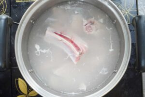 Pork ribs in the middle of boiling water